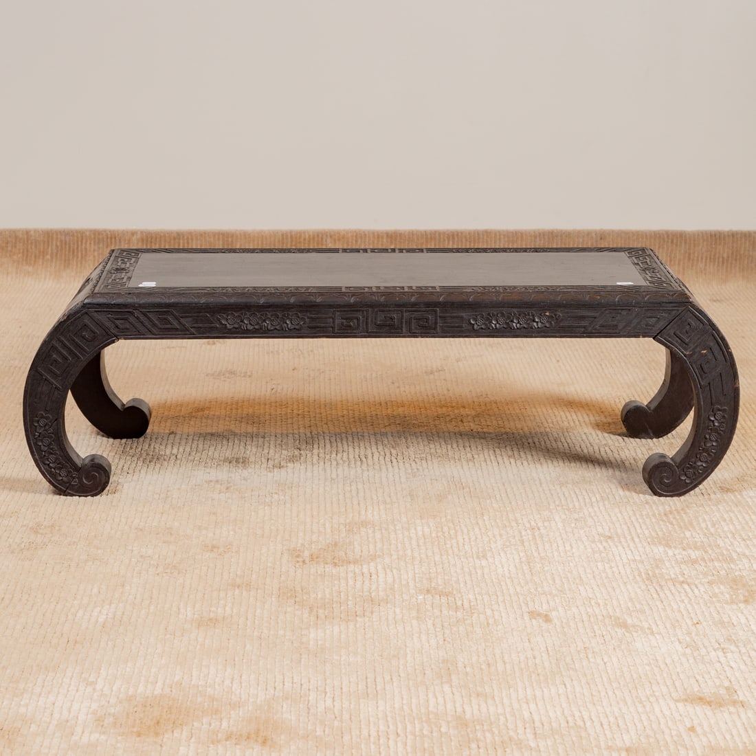 Chinese Ebonized & Carved Low Table: Carved top with matching apron extending into Chow form legs, 12 1/4 in. H, 42 in. W, 16 in. D