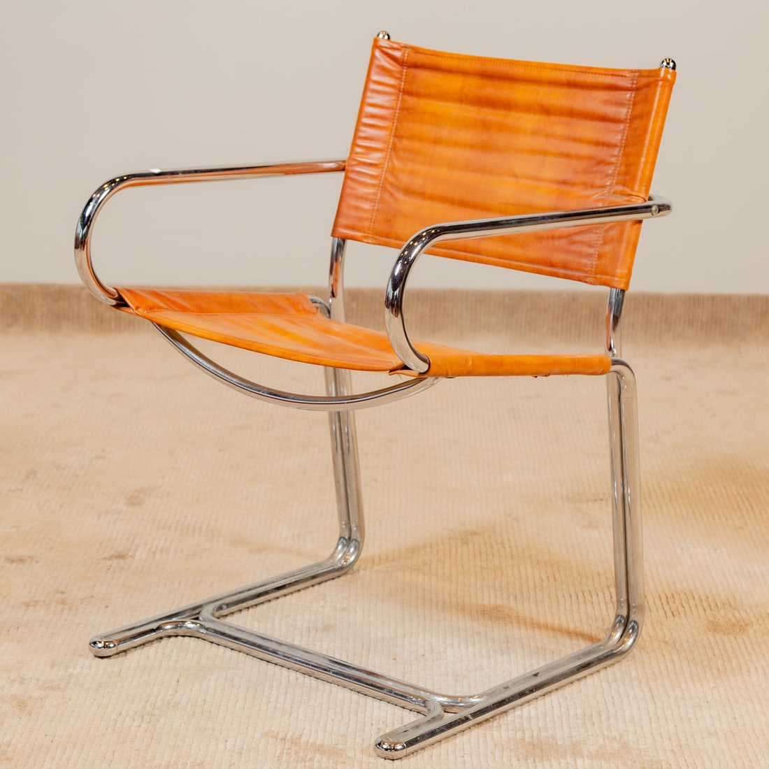 Chrome and Vinyl Sling Seat Cantilever Armchair: Sling back and seat attached to a chrome cantilever frame, 31 1/2 in. H, 22 in. W, 23 in. D