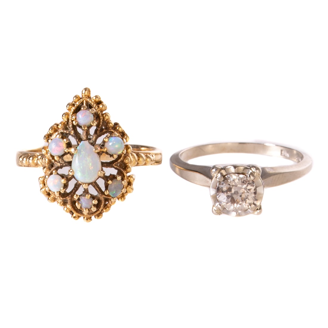 A Diamond Solitaire Ring & Opal Ring in 14K: 1) 14K white gold solitaire ring featuring an Old European cut diamond approx. 0.60 cts with an average color grade of M - N and an average clarity grade of SI, four prong set in an illusion setting,