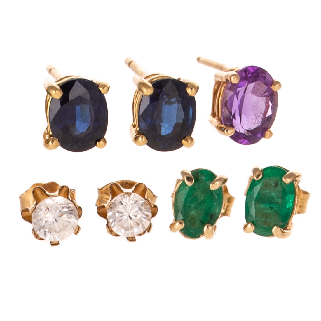 A Collection of Gemstone Studs: 1) 14K yellow gold studs featuring oval shaped blue sapphires 6.5 x 5.1 mm prong set in basket heads, posts, 2) 14K yellow gold studs featuring oval shaped emeralds 6.0 x 4.1 mm prong set in basket