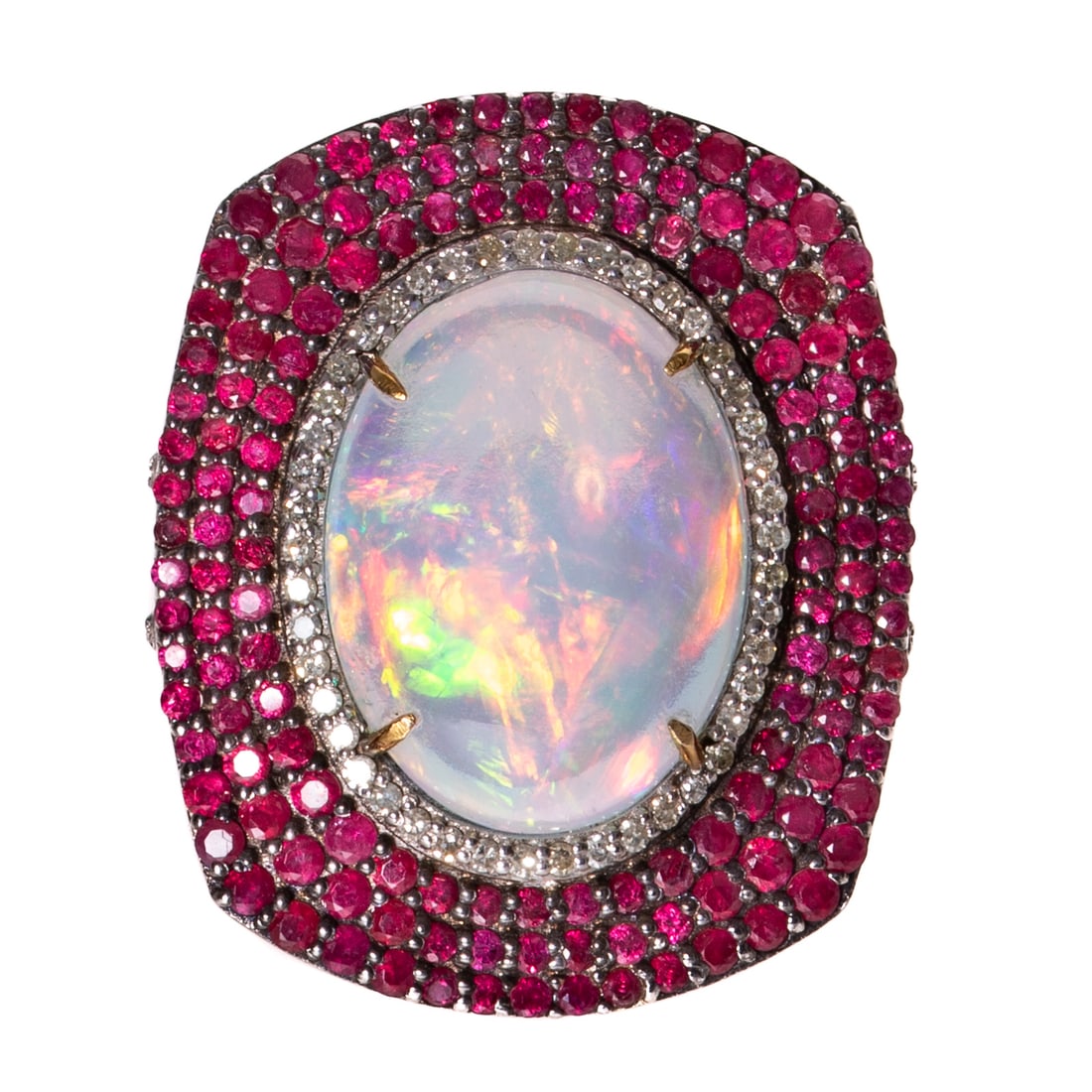 An Opal & Ruby Cocktail Ring in Sterling & 14K: Sterling silver and 14K yellow gold ring featuring an oval opal cabochon measuring 18.8 x 14.2 mm prong set in 14K yellow gold surrounded by a halo of round diamonds shared prong set and three outer h