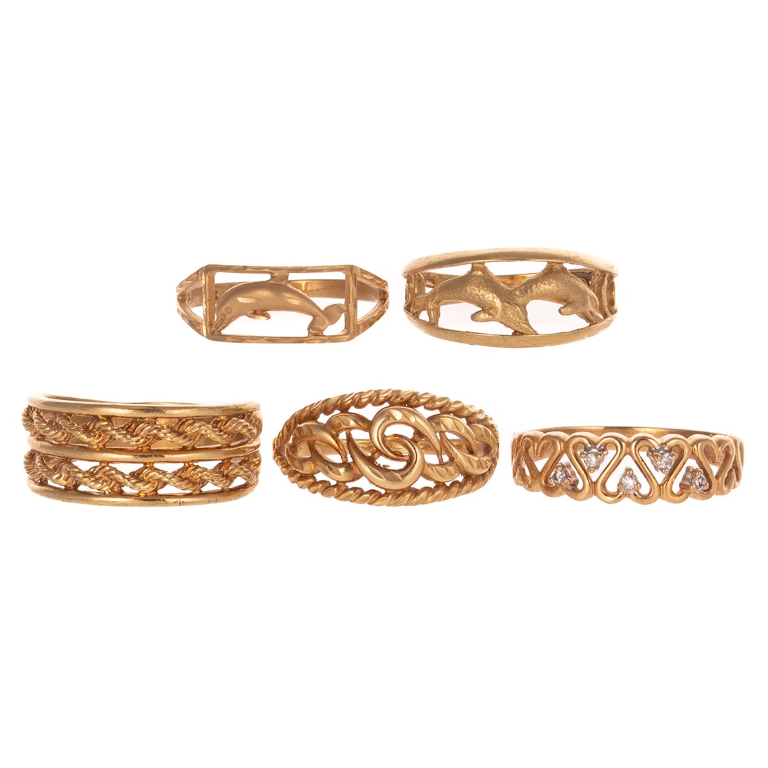 A Collection of Yellow Gold Bands in 10K: Five 10K yellow gold bands with varying designs including dolphins, hearts and braided designs, sizes range from 8.5 - 9.5, 13.1 grams tw Provenance: From the Estate of Nancy Muir, Baltimore, MD