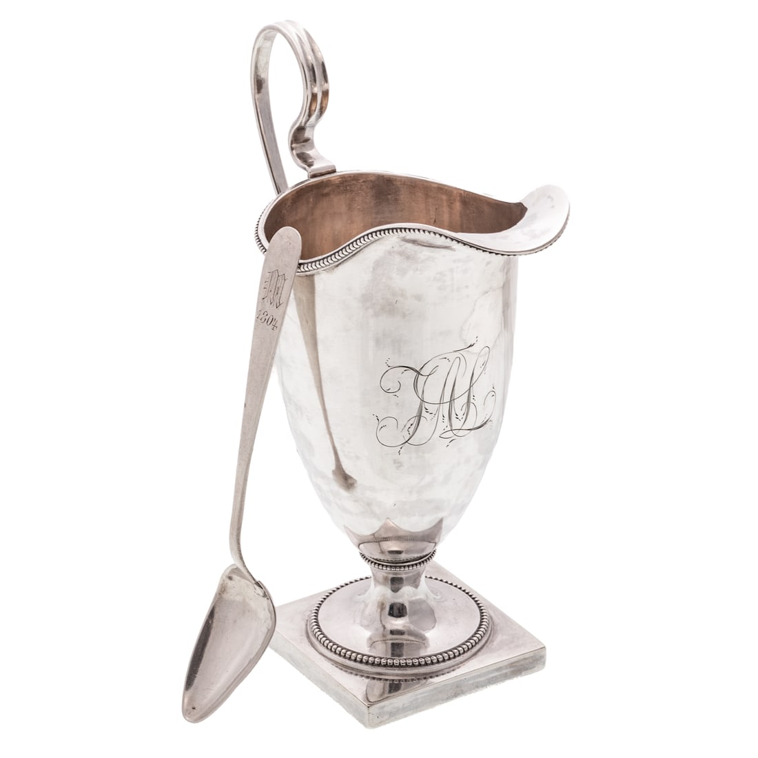 Baltimore Coin Silver Creamer by Littleton Holland: Active c.1800-1847, helmet-form, applied beaded rims, chased monogram, elongated handle, on a square foot, 6 1/2 in. H overall, 6.35 ozt. With a Littleton Holland coin silver teaspoon, "M" monogram, a