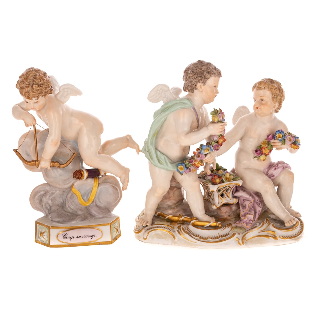 Two Meissen Putti Figural Groups: Late 19th/ 20th century, a Meissen porcelain Devisenkinder putti holding bow and arrow, with gilt accents, marked on bottom, 5 1/4 in. H, 4 in. W, approx. 2 1/2 in. D; and a Meissen porcelain putti