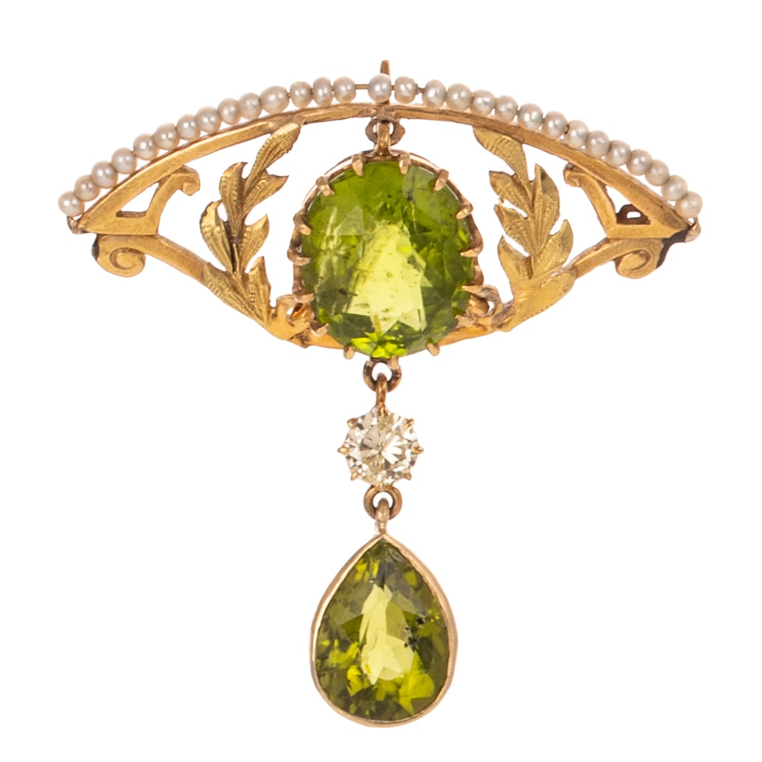 A Victorian Style Peridot Drop Pendant in 9K: 9K yellow gold pendant featuring a large oval shaped peridot prong set in the center of an open navette shaped base with textured foliate and seed pearl details suspending a round diamond, weighing 0.