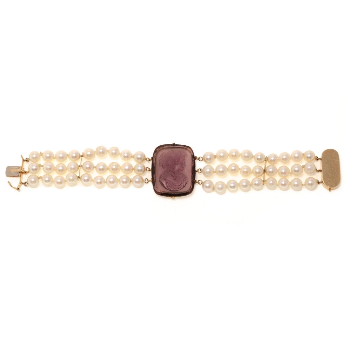 An Ametrine Intaglio Pearl Bracelet in 14K: 14K yellow gold bracelet featuring a central cushion shape ametrine intaglio depicting a portrait of a woman set in 10K yellow gold prong setting with a triple stand of cultured pearls measuring 6.5 -