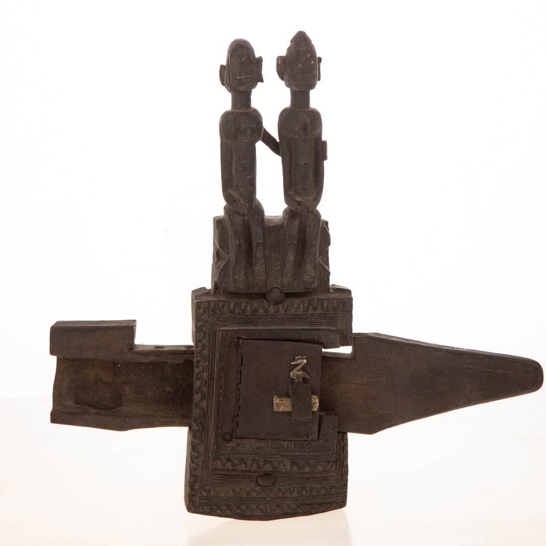 A Carved Wood African Door Lock: (Possibly Mali Dogon) A carved dark wood African door lock, 12 in. H, 12 1/4 in. W, 2 1/4 in. D