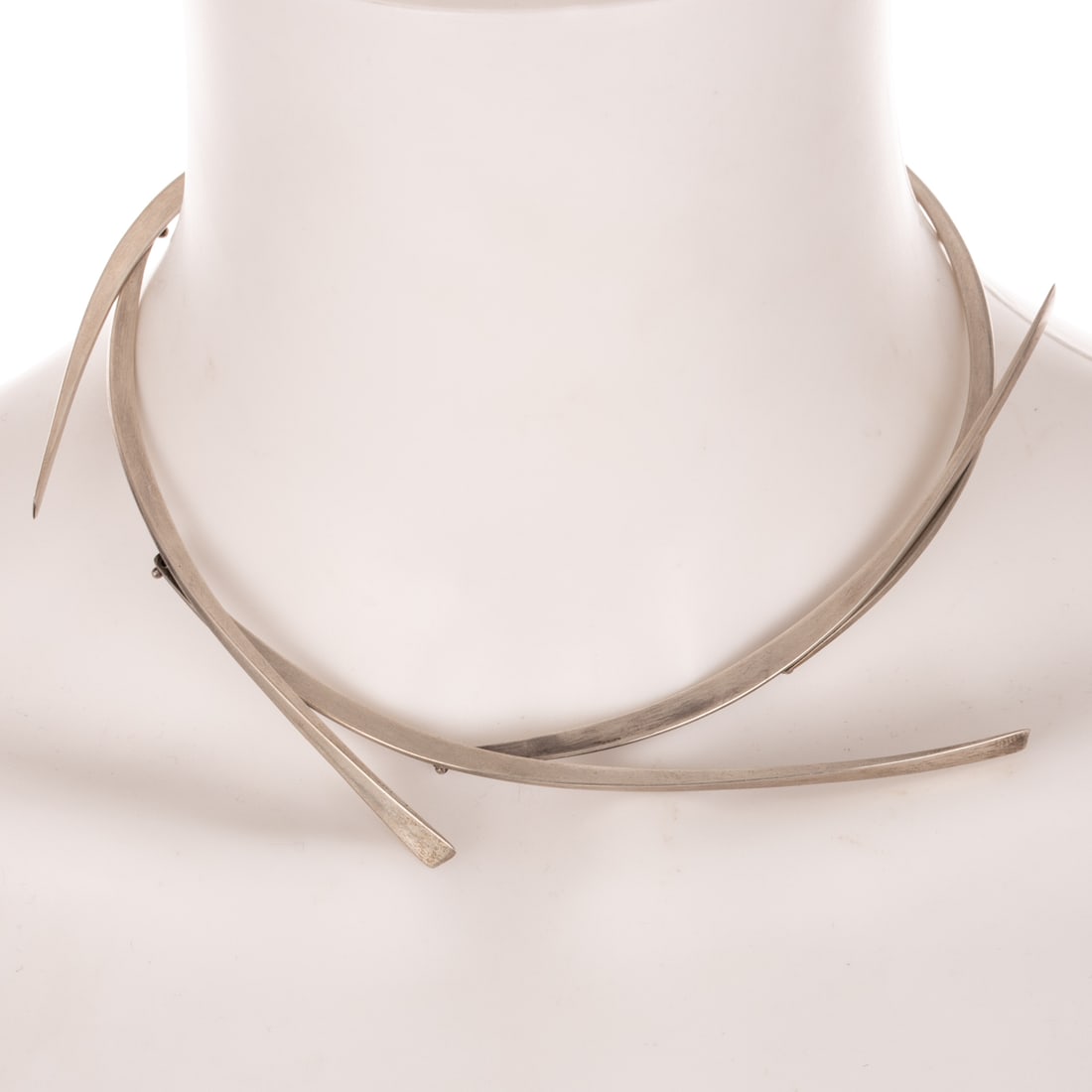 A Betty Cooke Boomerang Necklace in Sterling Silver: Sterling silver necklace by Betty Cooke (1924 - 2024), Baltimore, MD featuring four forged kinetic curved boomerangs, high polish finish, hook clasp, signed, interior Diam. 4 3/4 in., 38.3 grams Prove
