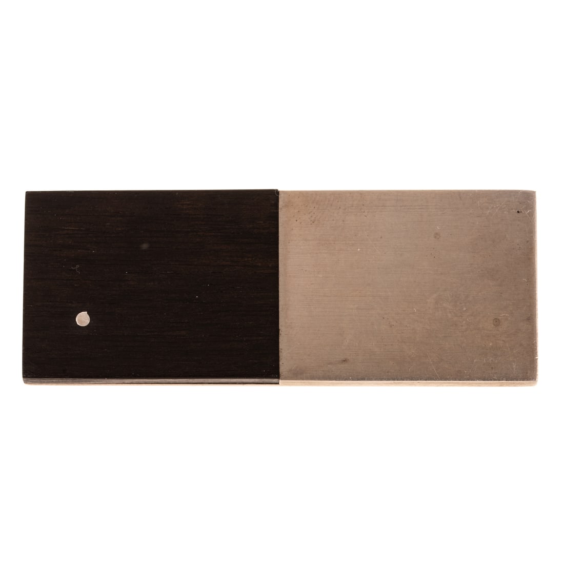 A Betty Cooke Ebony Rectangular Pin in Sterling Silver: Sterling silver brooch by Betty Cooke (1924 - 2024) Baltimore, MD rectangular form design with half ebony wood with sterling flush dot and half with high polish sterling silver, signed, 2 in. L, 21.5 