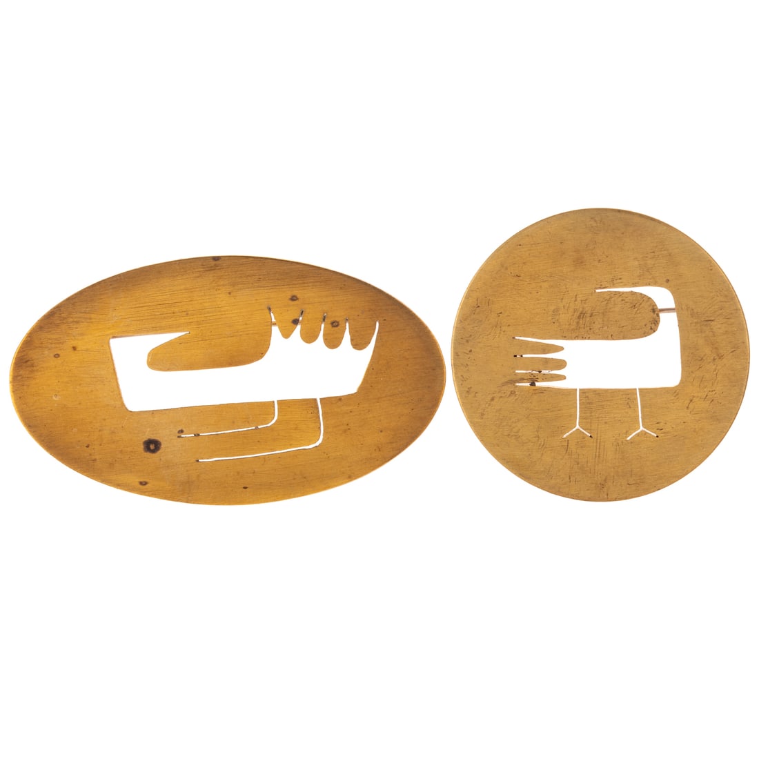 Two Brass Betty Cooke Disc Bird Brooches in Brass: Two brass brooches by Betty Cooke (1924 - 2024), Baltimore, MD matte finish with cut out birds, both signed, oval measures 1 5/8 in. W and round measures 1 3/4 in. Diam., 25.7 grams tw Provenance: Fro