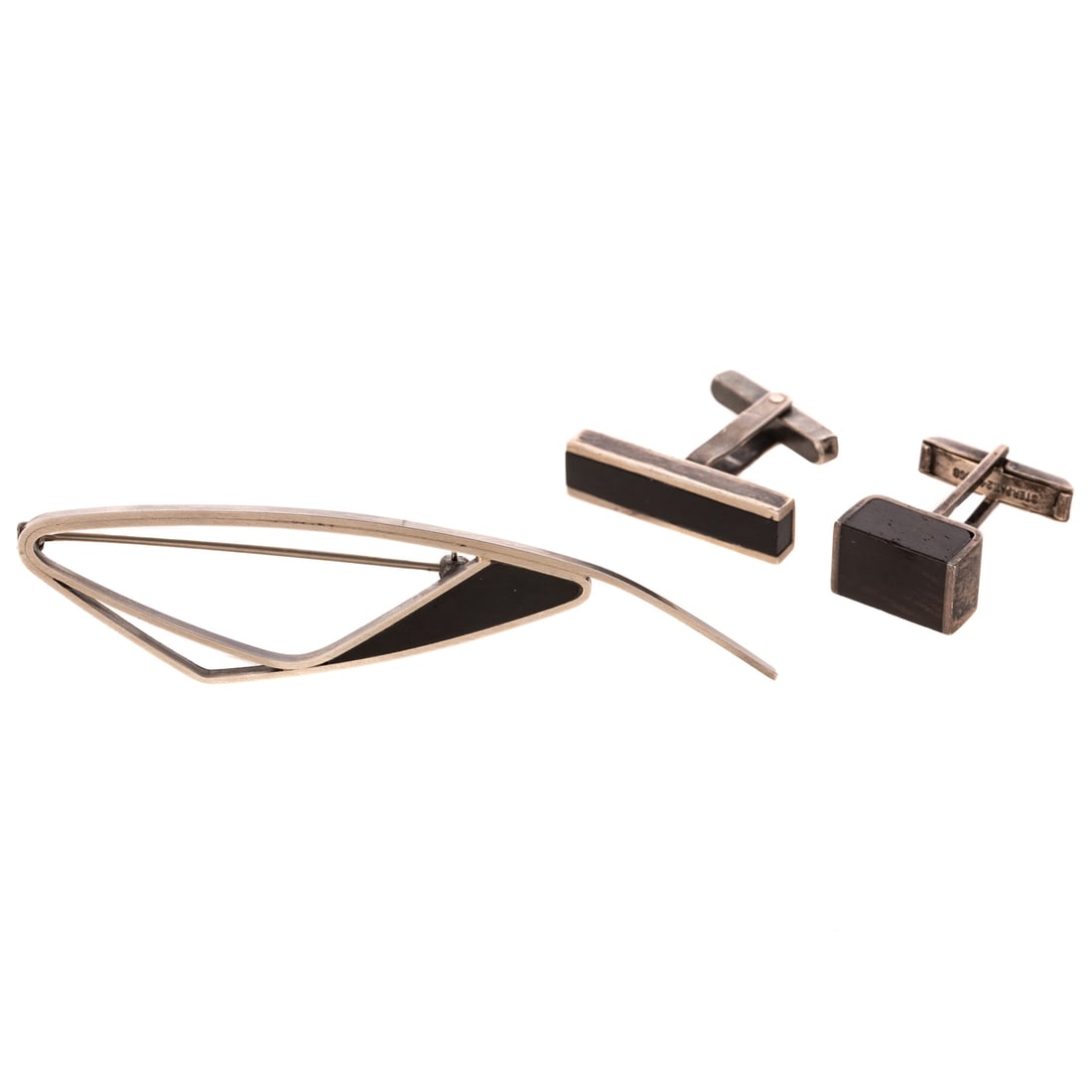 A Betty Cooke Brooch & Cufflinks in Sterling Silver: 1) Sterling silver brooch by Betty Cooke (1924 - 2024), Baltimore, MD featuring custom cut ebony wood in center of freeform design, signed, 3 1/4 in. L, and 2) Sterling silver mismatched cufflinks by 