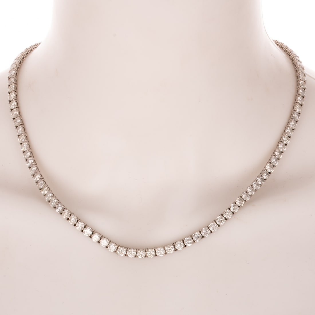 A 30.00 ctw Diamond Line Necklace in 14K: 14K white gold necklace featuring a line of round diamonds weighing approx. 30.00 ctw with an average color grade of H - I and an average clarity grade of SI - I individually prong set, hidden box
