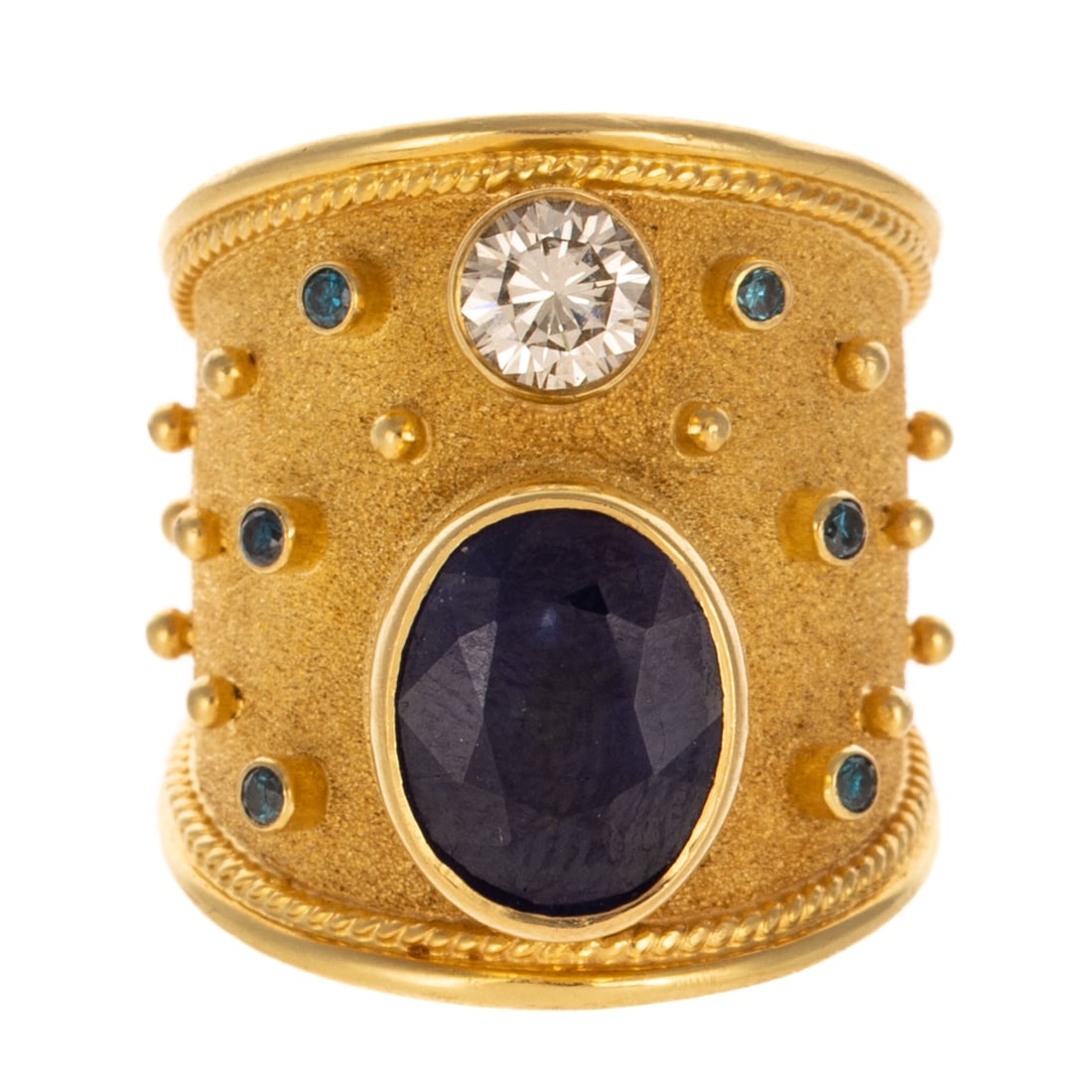 A Georgios Collection Sapphire & Diamond Band in 18K: 18K yellow gold wide Byzantine style band by Georgios Collection, Greece, featuring a bezel set oval sapphire weighing approx. 4.00 carats and a bezel set round diamond weighing approx. 0.65 carats