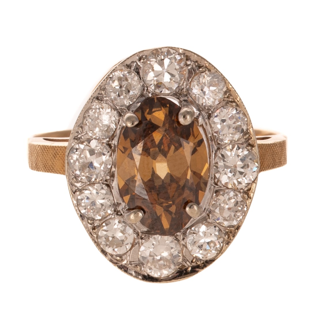 A 1.87 ct Cognac & White Diamond Ring in 14K: 14K yellow gold ring featuring a oval faceted cognac diamond weighing approx. 1.87 carats prong set with round and Old European cut white diamond halo weighing approx. 1.20 ctw with an average color g