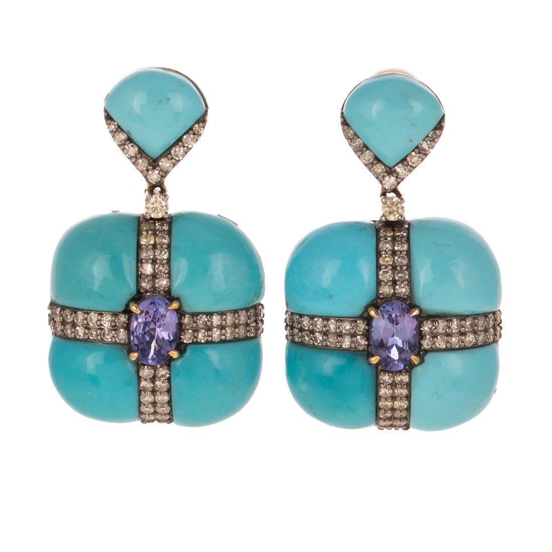 A Pair of Turquoise, Diamond & Tanzanite Earrings in Sterling Silver: Sterling silver earrings featuring oval shaped tanzanite measuring 5.7 x 4 mm prong set in the center of round diamond bands crossing over turquoise cabochons, all dangling below a line of round