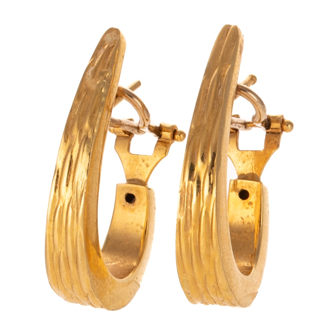 A Pair of Textured Hoop Earrings in 18K: 18K yellow gold Italian tapered textured hoop earrings made in Italy, posts with Omega backs, 1 1/8 in. L, 5.9 grams Provenance: From a Baltimore estate