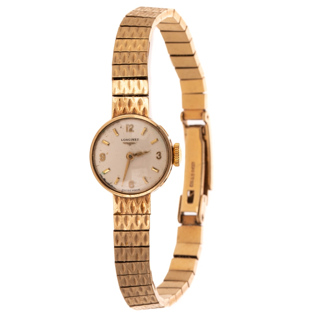 A 1962 Longines Watch in 9K: 1962, 9K yellow gold wrist watch by Longines, round white dial with Arabic numerals and dash indices, 18 mm, tapered engraved bracelet with fold over clasp, mechanical movement, serial #12112344, 7 in