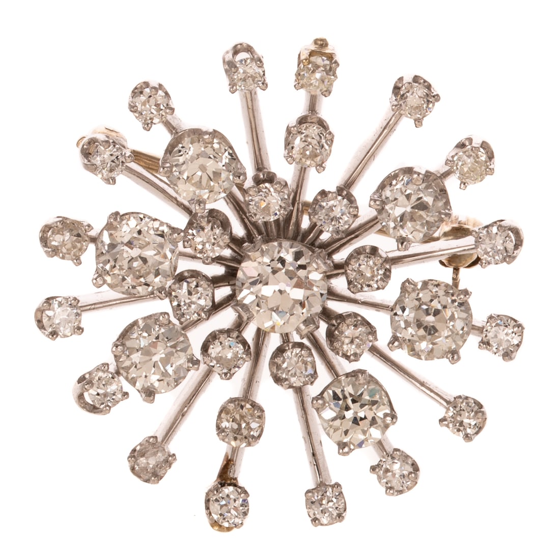 A 5.75 ctw Diamond Starburst Pin/Pendant in Platinum: Platinum pin/pendant featuring a Old European diamond prong set in the center of a radiating burst of Old European diamonds all prong set weighing approx. 5.75 ctw with an average color grade of I - J