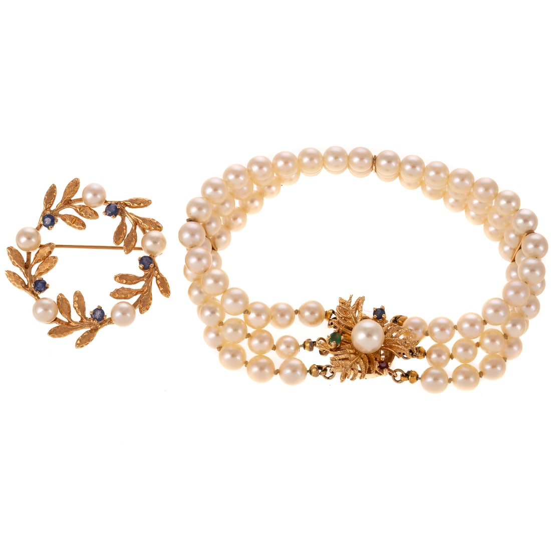 A Triple Strand Pearl Bracelet & Circle Brooch in 14K: 1) Triple strand cultured pearl bracelet, each very fine well matched pearl measuring 5 mm, with three gold bar connectors and a 14K yellow gold foliate clasp with a round ruby, sapphire, and emerald 