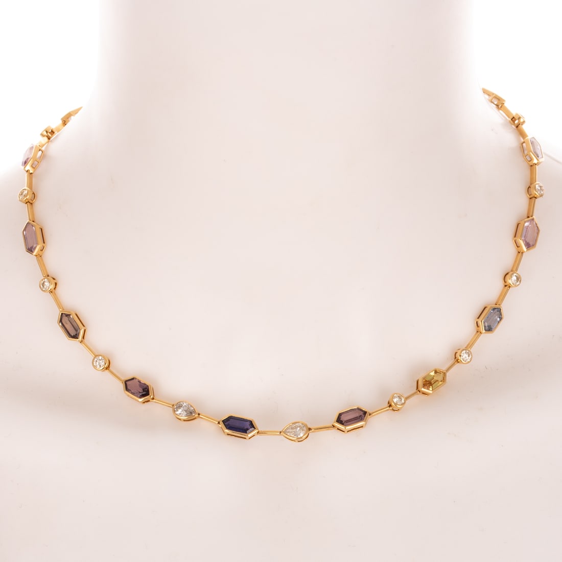 A GIA Unheated Sapphire Necklace in 14K: 14K yellow gold necklace by Oscar Friedman featuring a line of hexagonal multi-colored unheated sapphires weighing approx. 14.56 ctw, accompanied by GIA Gemological Report #2225870235, bezel set