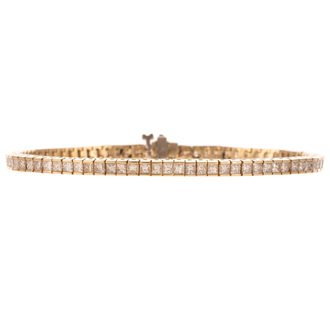 A 3.00 ctw Diamond Line Bracelet in 14K: 14K yellow gold bracelet featuring a line of princess cut diamonds weighing approx. 3.00 ctw with an average color grade of G - H and an average clarity grade of VS, hidden box clasp with under