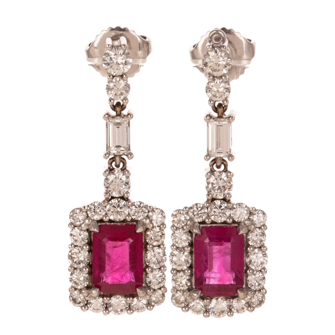 A Pair of Ruby & Diamond Dangle Earrings in 18K: 18K white gold earrings featuring articulated lines of round and baguette diamonds prong set suspending emerald cut rubies weighing approx. 2.70 ctw prong set in the center of a halo of round diamonds