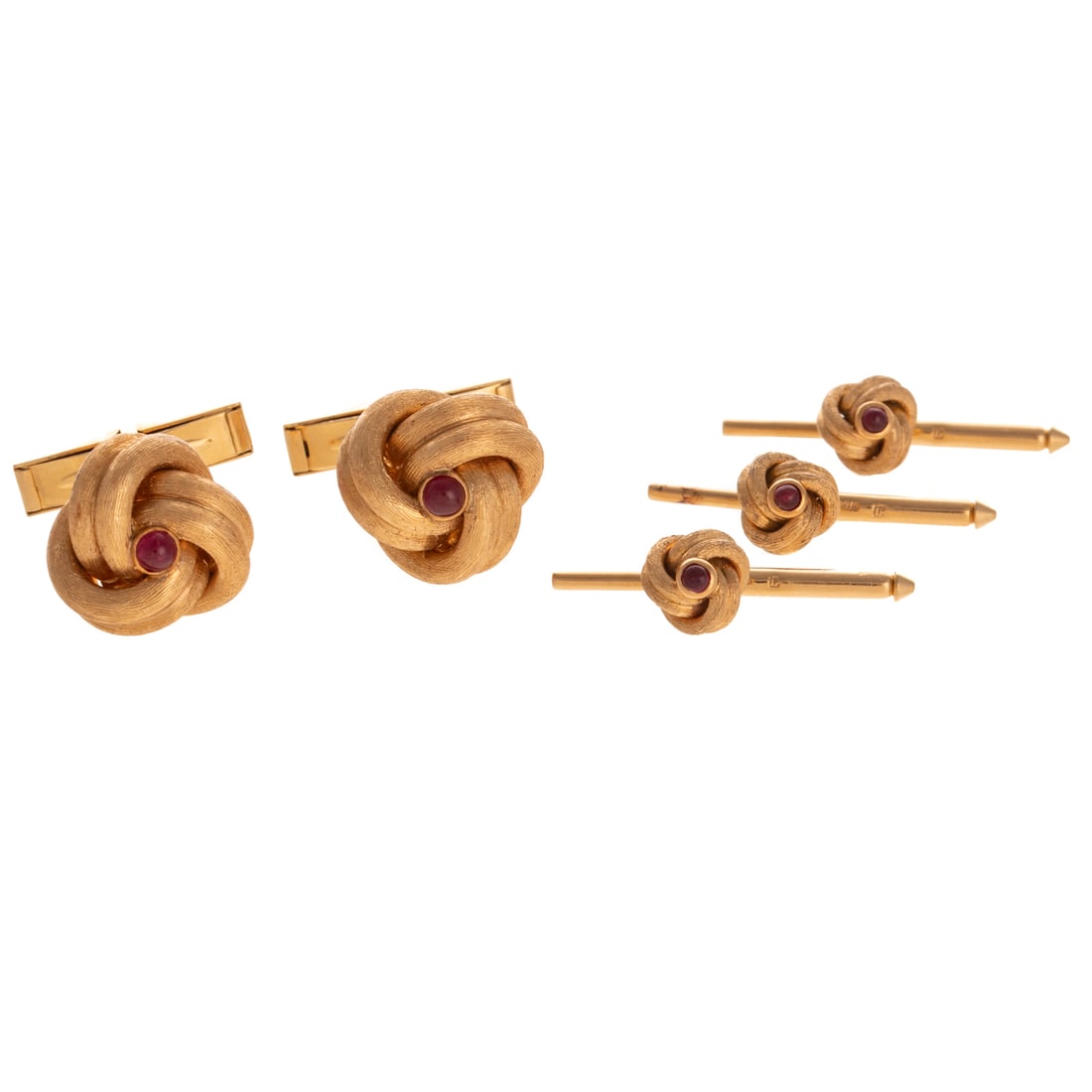 A Ruby Knot Cufflink & Stud Set in 14K: 14K yellow gold matching cufflink and stud set featuring bezel set rubies in center of Florentine finish double row knot design, cufflinks measure 5/8 in. W with swivel bar closure, studs measure 1/4