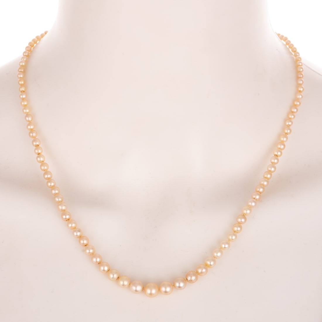 A Strand of Pearls with 1.00 ct Diamond Clasp in Platinum: Strand of graduated cultured pearls ranging in size from 2 - 7 mm featuring a marquise cut diamond weighing approx. 1.00 carats with an average color grade of I - J, bezel set on platinum box clasp wi