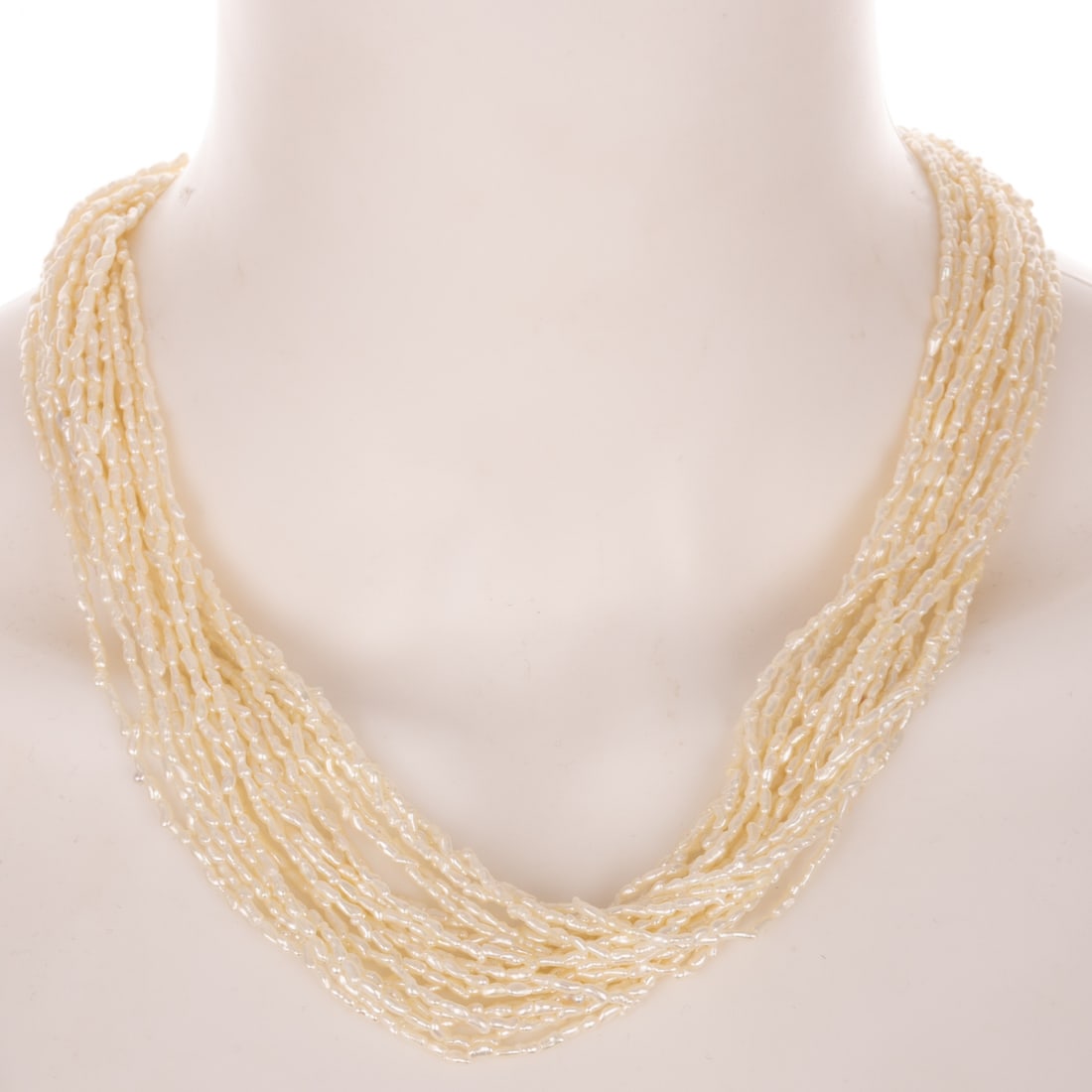 A Multi-Strand Pearl Necklace with Diamond Clasp in 18K: 18K yellow gold oval large barrel clasp with diamonds weighing approx. 0.50 ctw set in crisscross design, connecting a multi strand high luster pearl necklace, 20 in. L, 63.8 grams Provenance: From a 