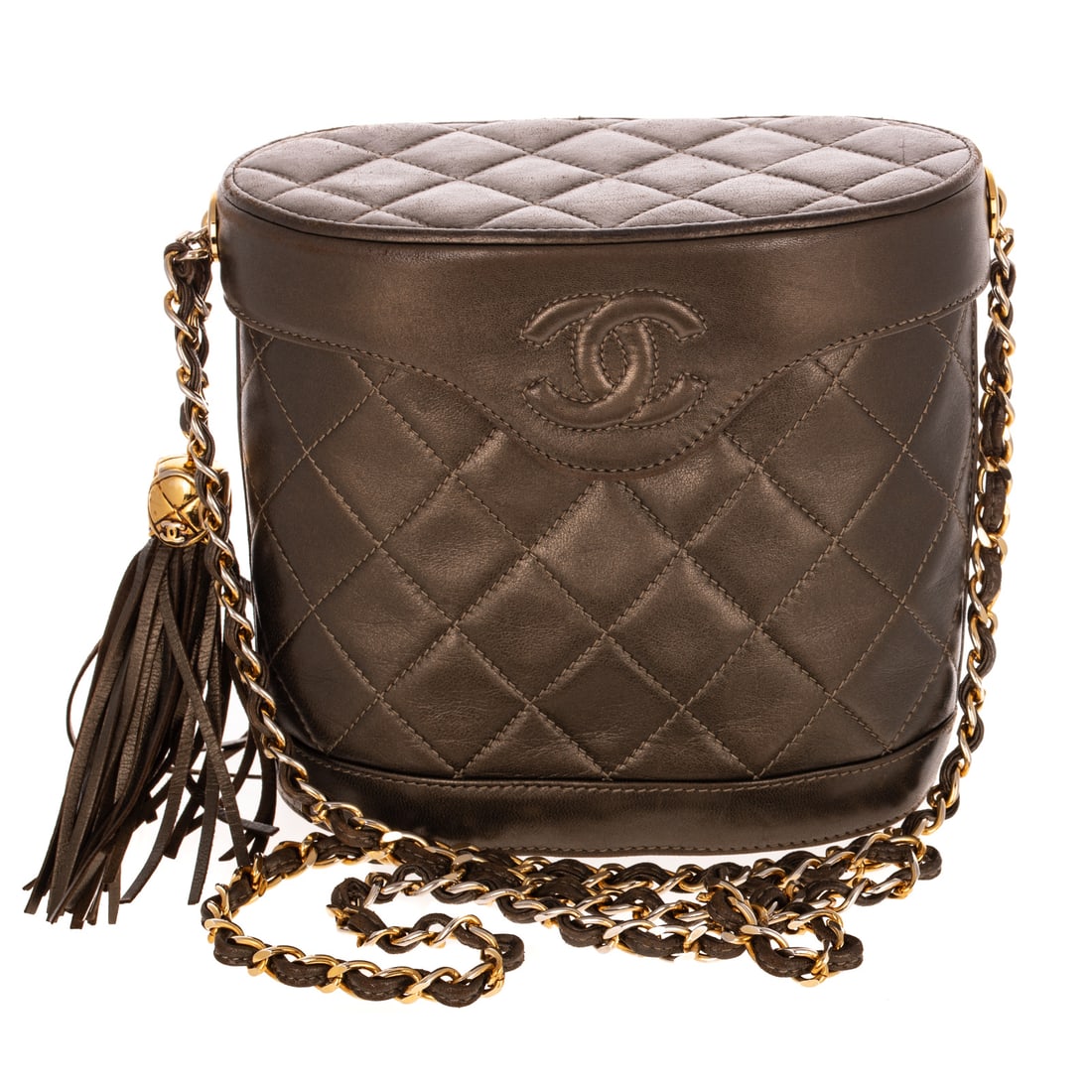 A Vintage Chanel Tassel Vanity Case: A dark green quilted lambskin Chanel Tassel Vanity Case from the 1989-1991 collection by Karl Lagerfeld with gold tone hardware, chain-link shoulder strap, tassel and chain-link accents, and