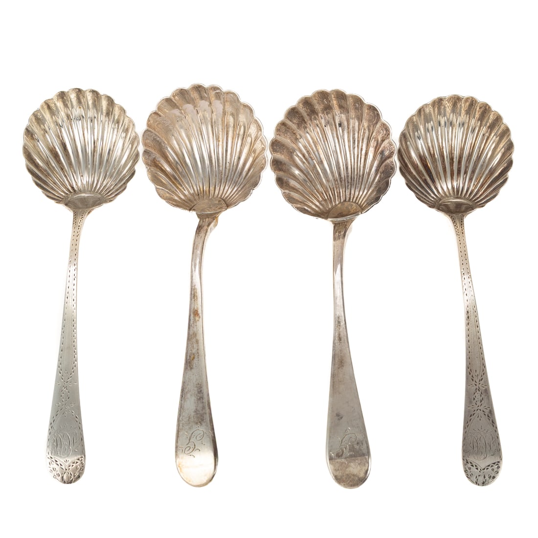 Four George III Silver Shell Sauce Ladles: Including a pair by George Smith III, London, 1785, with bright-cut and monogrammed handles, 7 1/4 in. L, 2.3 ozt.; a pair by Alexander Barnet, London, date mark is rubbed, monogrammed, 7 in. L, 3.8 o