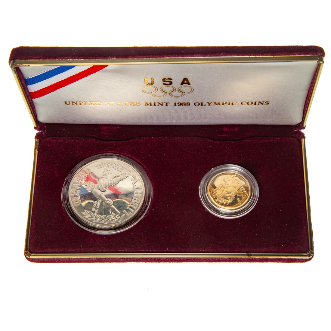 1988 Olympics Two-Coin Gold Commemorative Proof Set: Proof set with silver dollar and $5 gold which is .2419 oz. Comes in rec mint case but no box, COA is present Provenance: From the Estate of Thomas J. DePrince, Rehoboth, DE