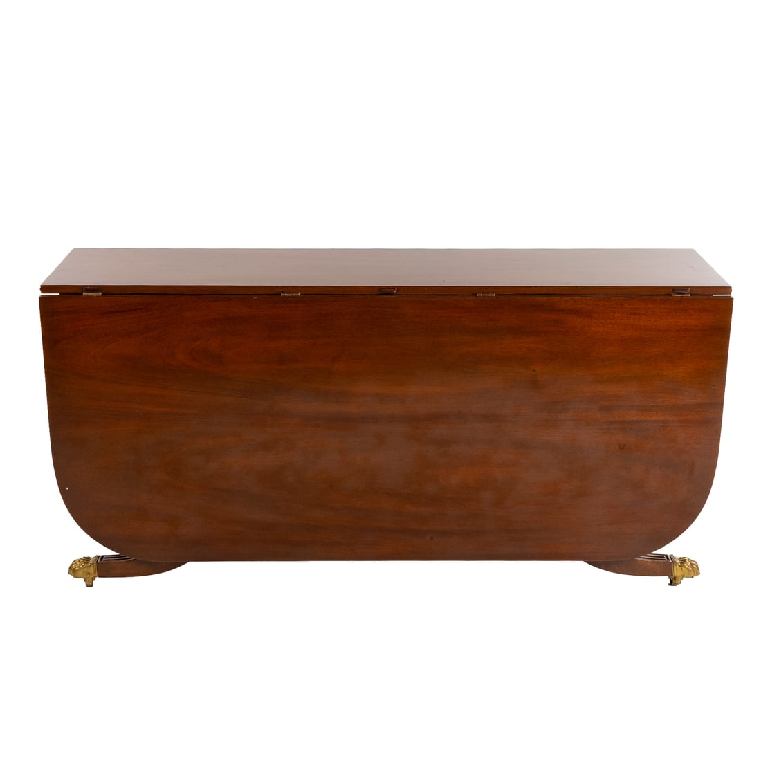 Federal Style Narrow Mahogany Drop Leaf Table: Double drop leaf with reeded edge and curved cornered top over a reeded trestle base connected to sabre legs ending in castered lion's paw feet, 28 1/2 in. H, 56 in. W, 15 in. D (closed) Provenance: