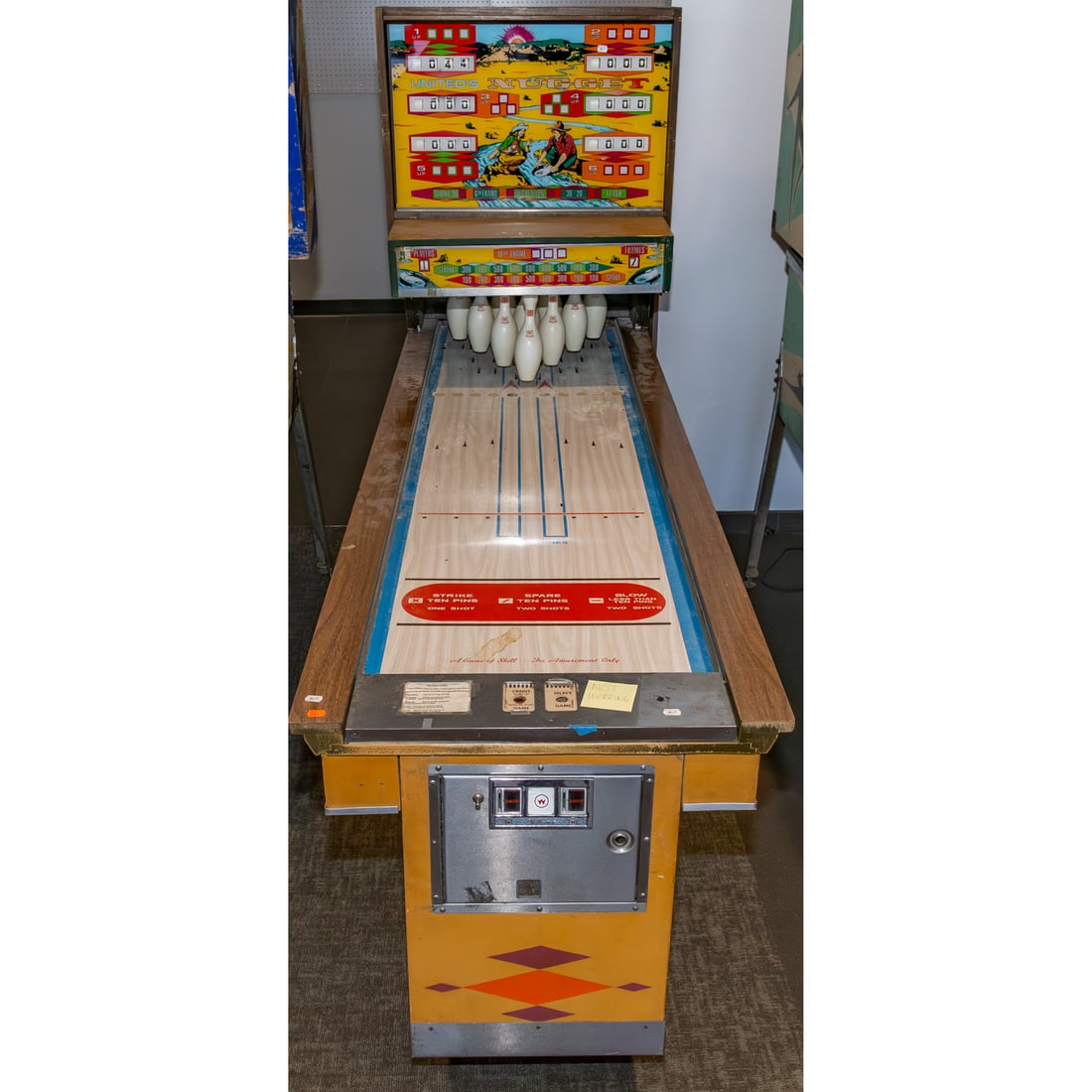 United's "Nugget" 1977 Vintage Bowling Game: Nugget was produced by United Amusement Co. in 1977, 67 1/2 in. H, 30 1/2 in. W, 111 in. D Provenance: From a Baltimore Collector, Known Locally as the "Pinball Wizard"