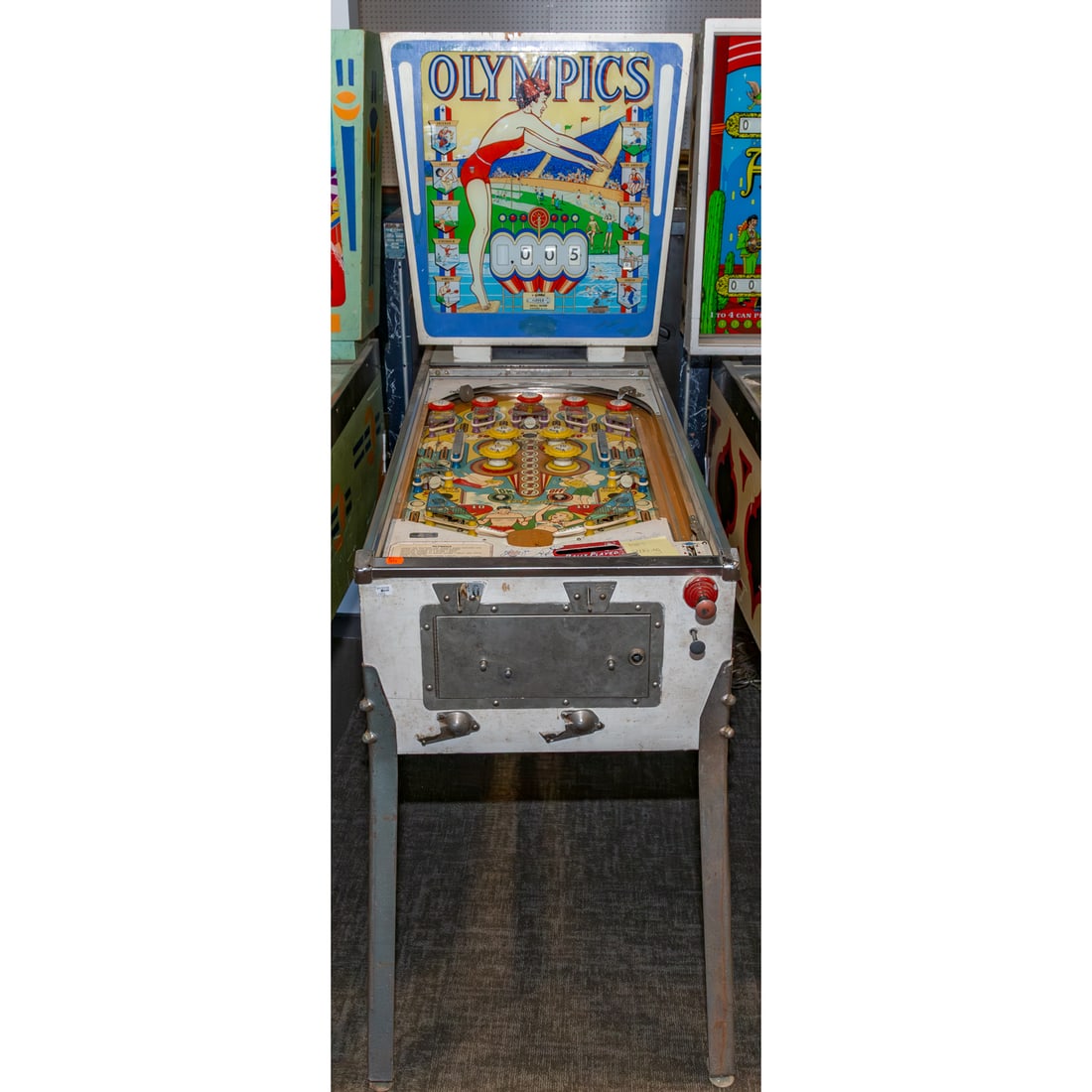 Gottlieb's 1962 Vintage "Olympics" Pinball Machine: 69 in. H, 26 in. W, 54 in. D Provenance: From a Baltimore Collector, Known Locally as the "Pinball Wizard"