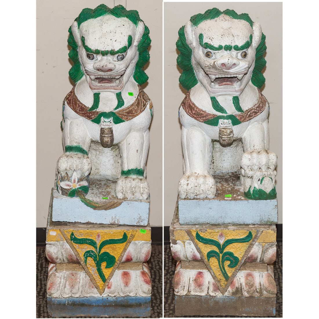 A Large Pair of Painted Stone Foo Dogs: A large pair of painted carved stone foo dogs, foo dog and base are separate pieces, foo dogs: 31 1/2 in. H, 15 in. W, 24 in. D, bases: 15 in. H, 17 in. W, 25 in. D Provenance: Originally commissioned