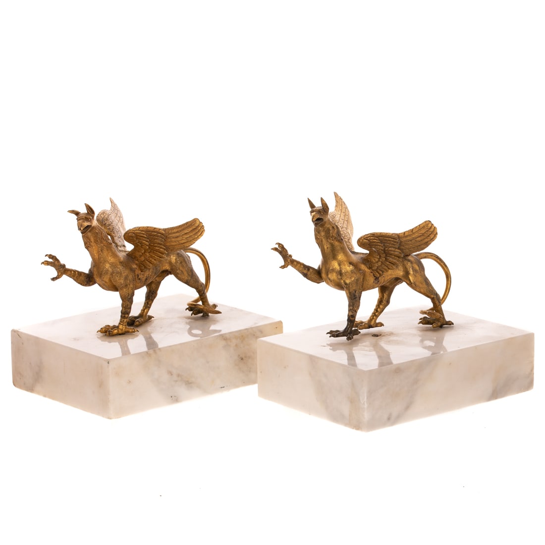 A Pair of Gilt Metal Griffins: A pair of gilt metal griffins on white marble bases, approx. 6 1/4 in. H, 7 in. L, 5 in. W