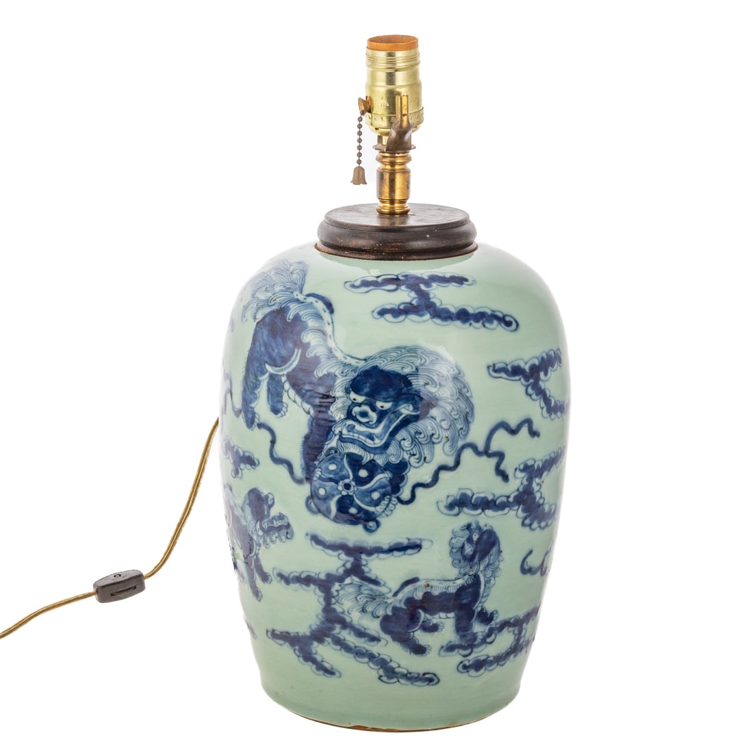 A Chinese Porcelain Foo Dog Table Lamp: A blue on celadon Qing Dynasty style jar converted into a table lamp depicting three foo dogs among the clouds, unmarked, 16 in. H, approx. 8 1/2 in. Diam.