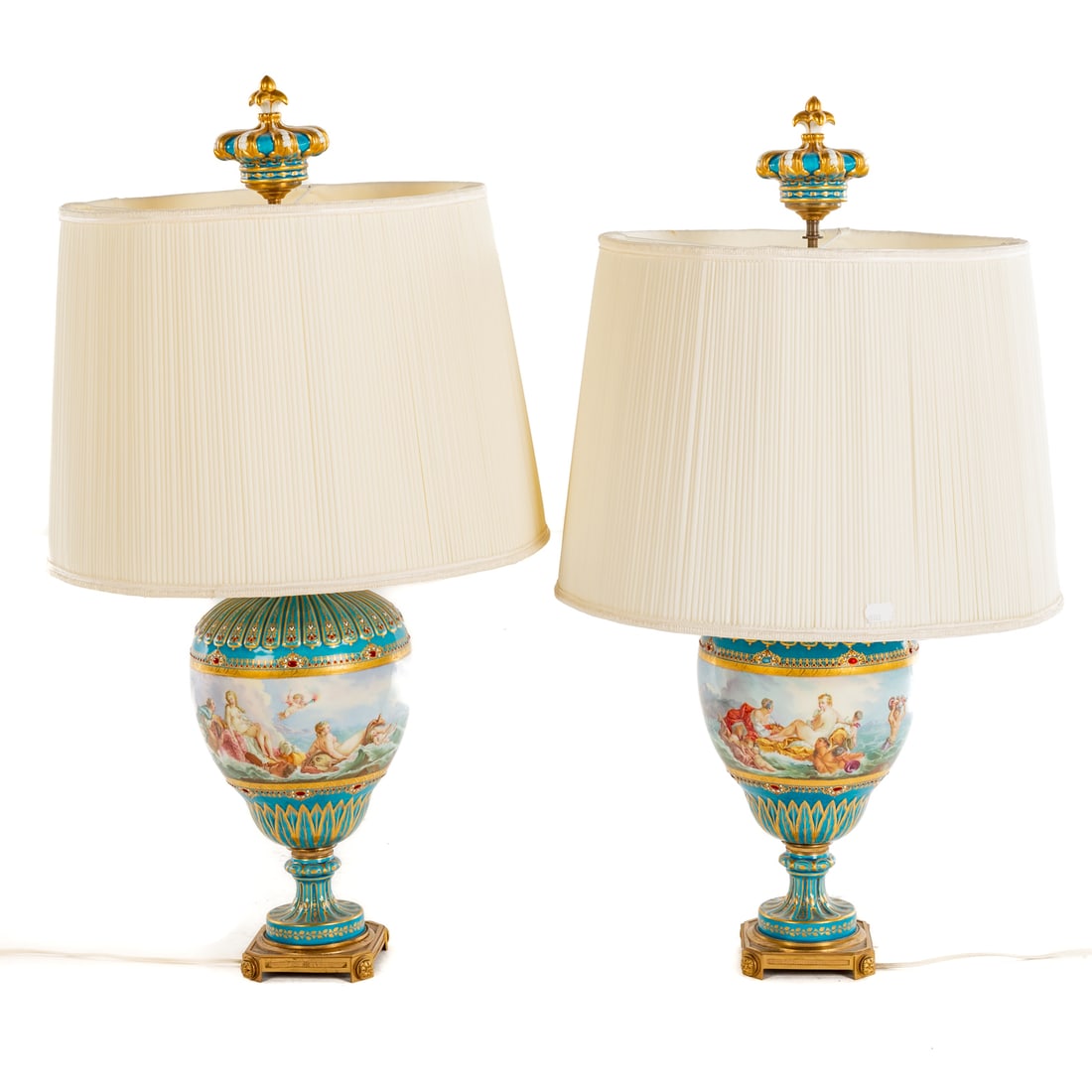A Pair of Sevres Style Table Lamps: A pair of robin egg blue ground Sevres style table lamps, paint enhanced decorated with images of Venus riding waves surrounded by putti, mermen and attendants, jeweled boarders and gilt accents,