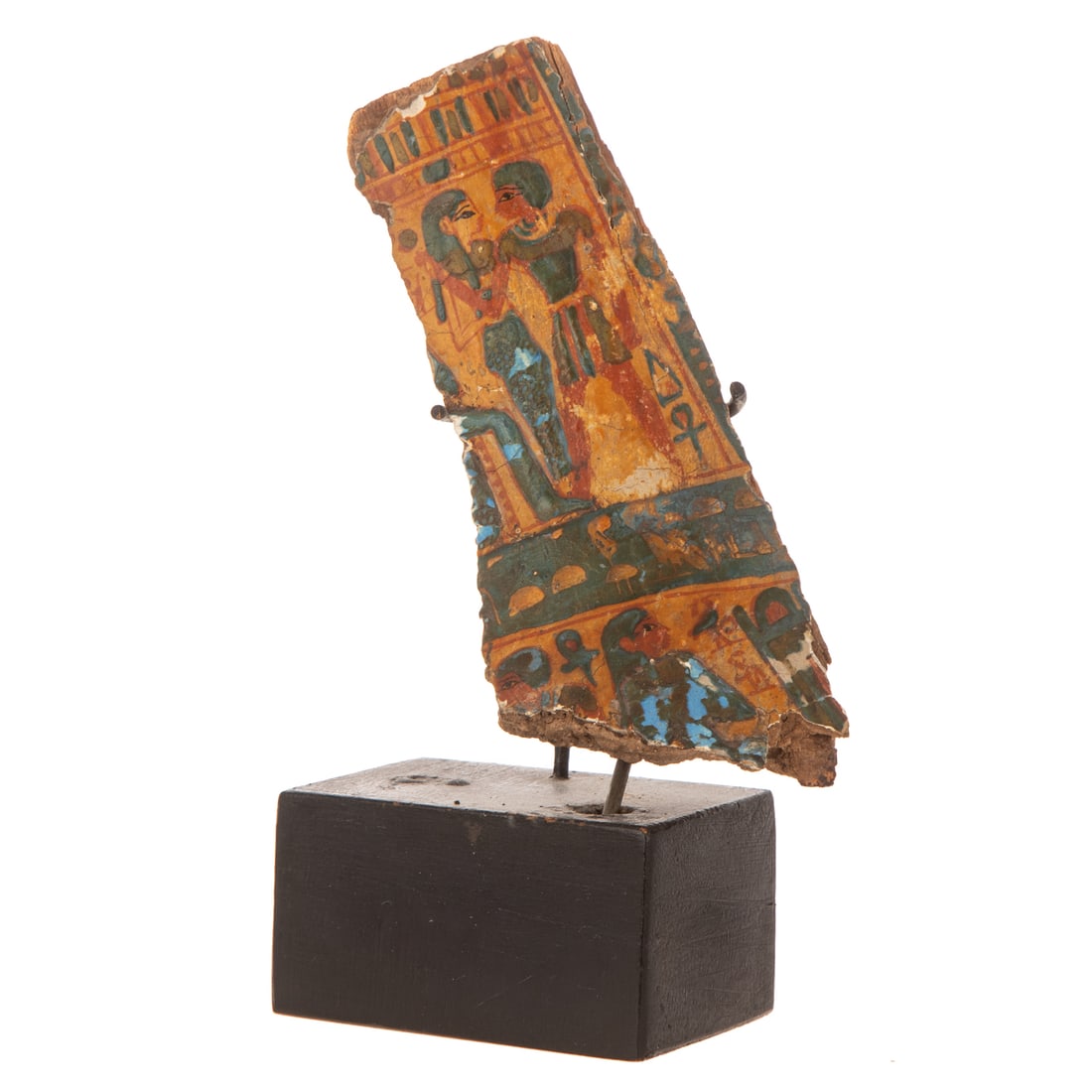 An Egyptian Painted Wood Fragment: An Egyptian painted wood fragment as though from a sarcophagus, New Kingdom manner, depicting a female and male figure standing side by side with ankh and falcon figures associated with Horus, along