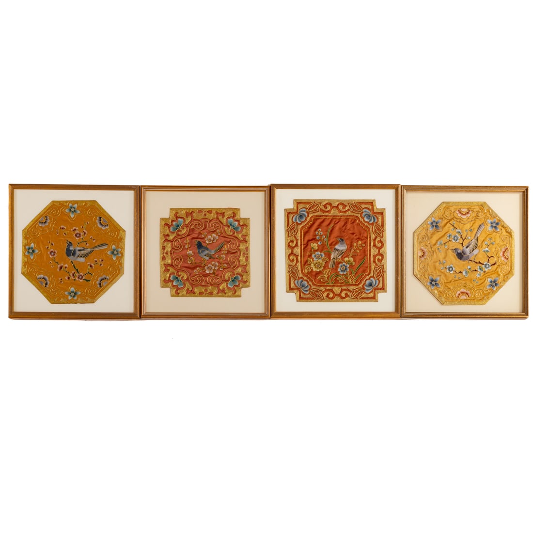 Four Pieces of Chinese Silk Embroidery: Includes two pairs, one orange and multicolor octagonal embroidered silk depicting a central bird figure seated on a cherry blossom branch surrounded by flowers. A red and multicolor pair of
