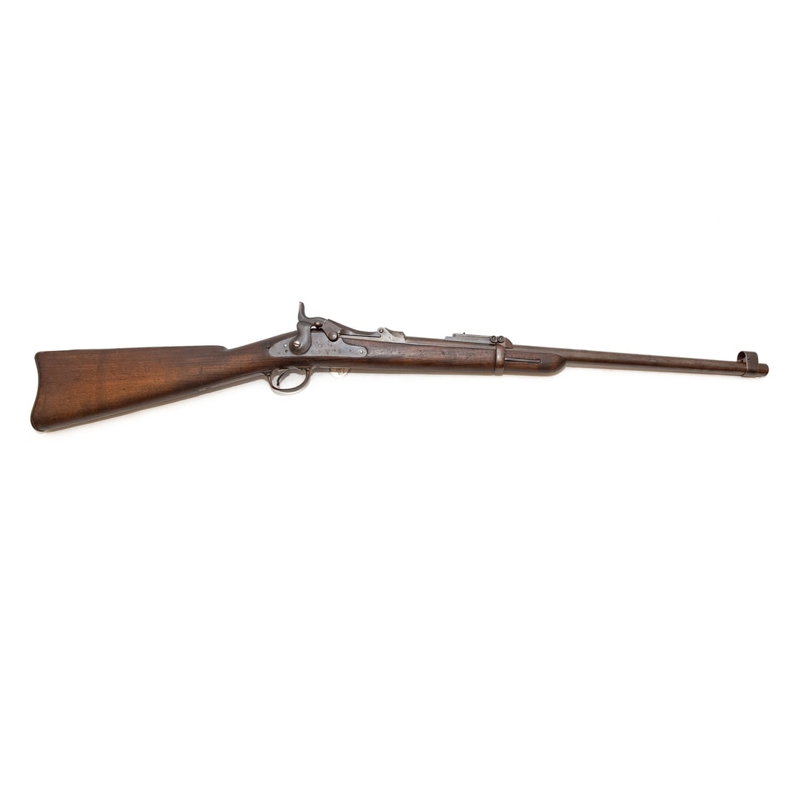 A Springfield Model 1884 Trapdoor Carbine Rifle: Serial number 329911, stamped at breech; .45/70 caliber; the barrel, 22 in. L; fitted with a saddle ring; a cleaning rod in butt stock; calibrated three-leaf rear sight and hooded front sight; Marked 