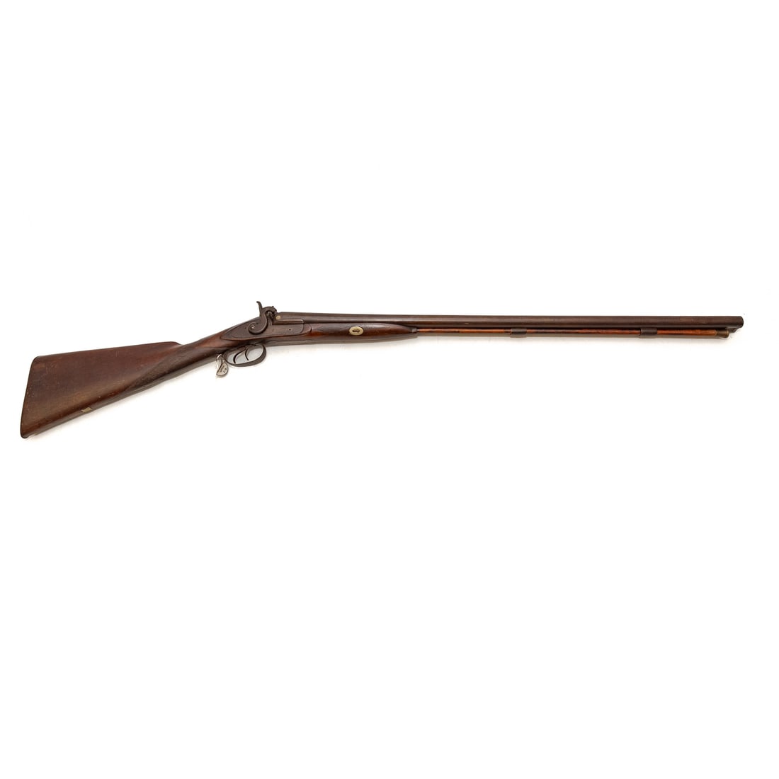 An American Double-Barrel Percussion Shotgun: Circa late 19th century; no visible markings, likely rubbed; .69 caliber; 32 in. L, barrel; checkered grip and decoration in wood; with ram rod; operations functional; 45 1/2 in. L, overall Provenance