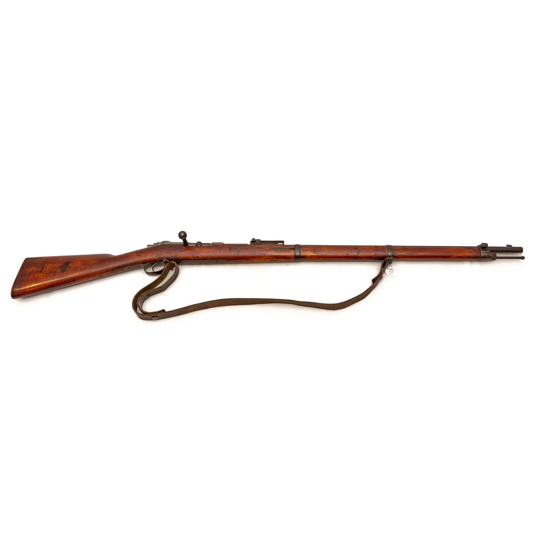 A German Model 1871/1874 Mauser Rifle: Serial number 2808, marked twice on left side of receiver, on bolt handle, and on safety switch; 11x60 caliber; the barrel, 31 in. L; with leather shoulder strap; proof marks located on barrel bands, 