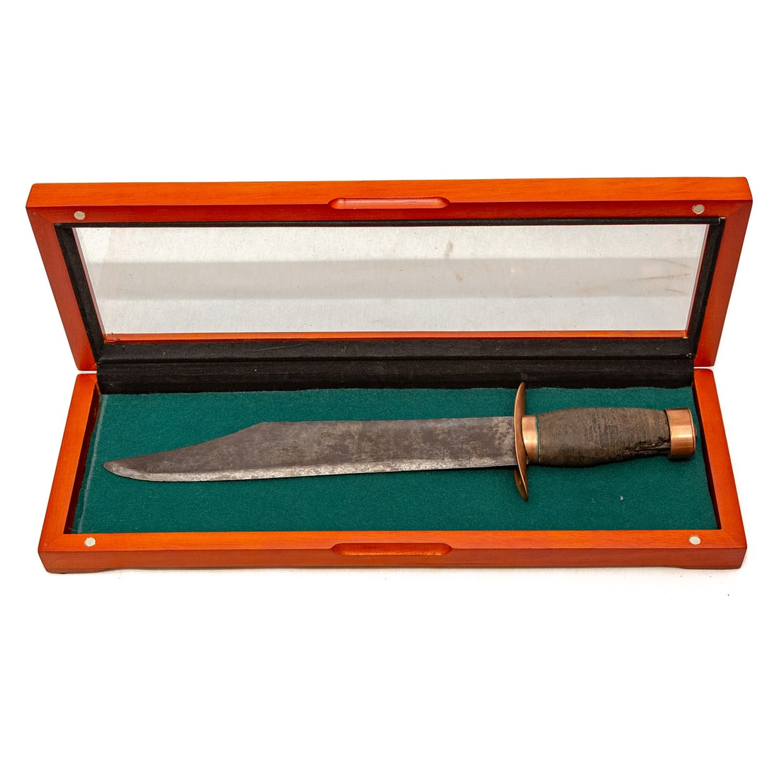 A Bowie Style Fighting Knife: The blade marked "Martin," the rest indistinctly marked; copper attachments; held in case display; 14 in. L overall Provenance: From The Estate of Timothy Lee App, Baltimore, MD