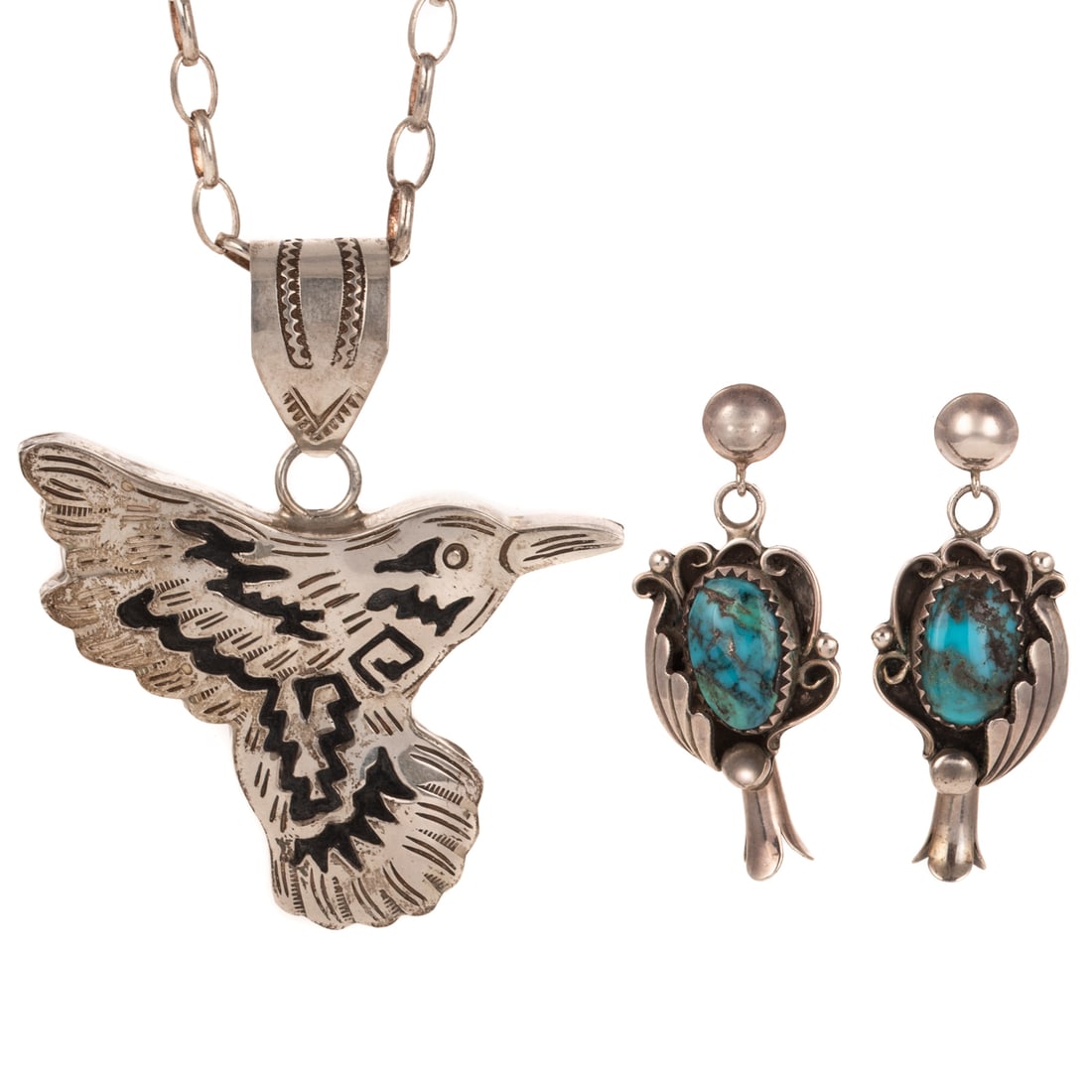An Alonzo Mariano Pendant & Squash Blossom Earrings in Silver: 1) Sterling silver hummingbird pendant by Navajo artist Alonzo Mariano signed, 2 5/8 x 2 1/4 in., suspended from a cable link chain, lobster clasp, 27 1/4 in. L, and 2) Silver Navajo squash blossom ea