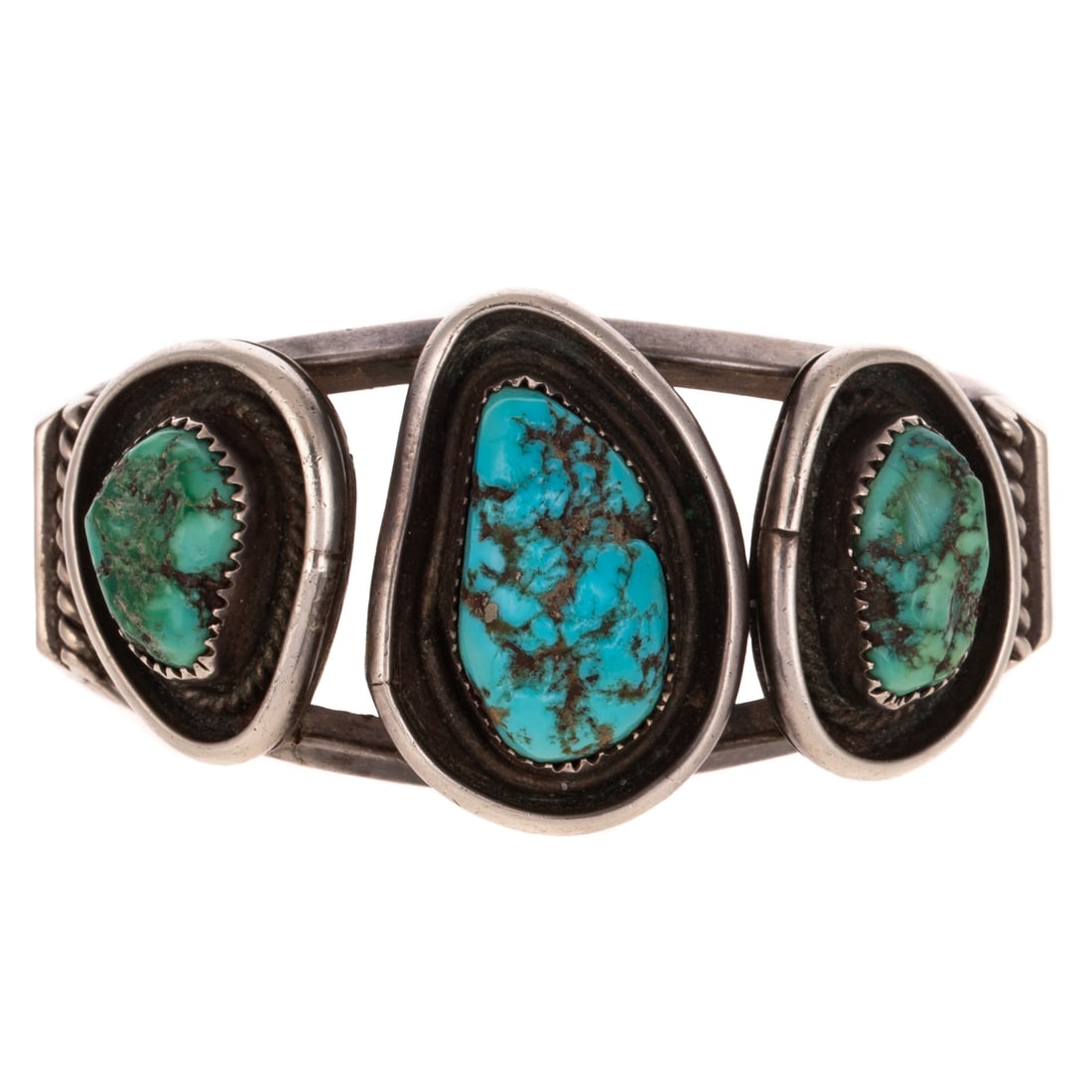 A David K. Lister Navajo Turquoise Cuff in Sterling Silver: c. 1970s, Sterling silver cuff bracelet by Navajo artist David K. Lister, featuring freeform nugget green and blue turquoise in twist rope bezels, split cuff, signed, 2 3/8 interior Diam., 56.1 grams
