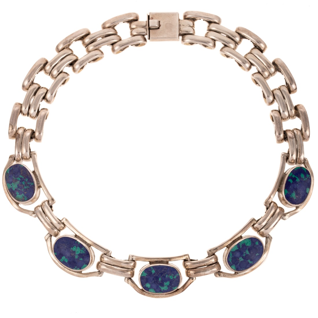 A Substantial Azurmalachite Necklace in Sterling Silver: Sterling silver Mexican necklace featuring five central oval cabochon azurmalachite bezel set in open links with panther links in back and box clasp, approx. 16 in. L, 225.0 grams