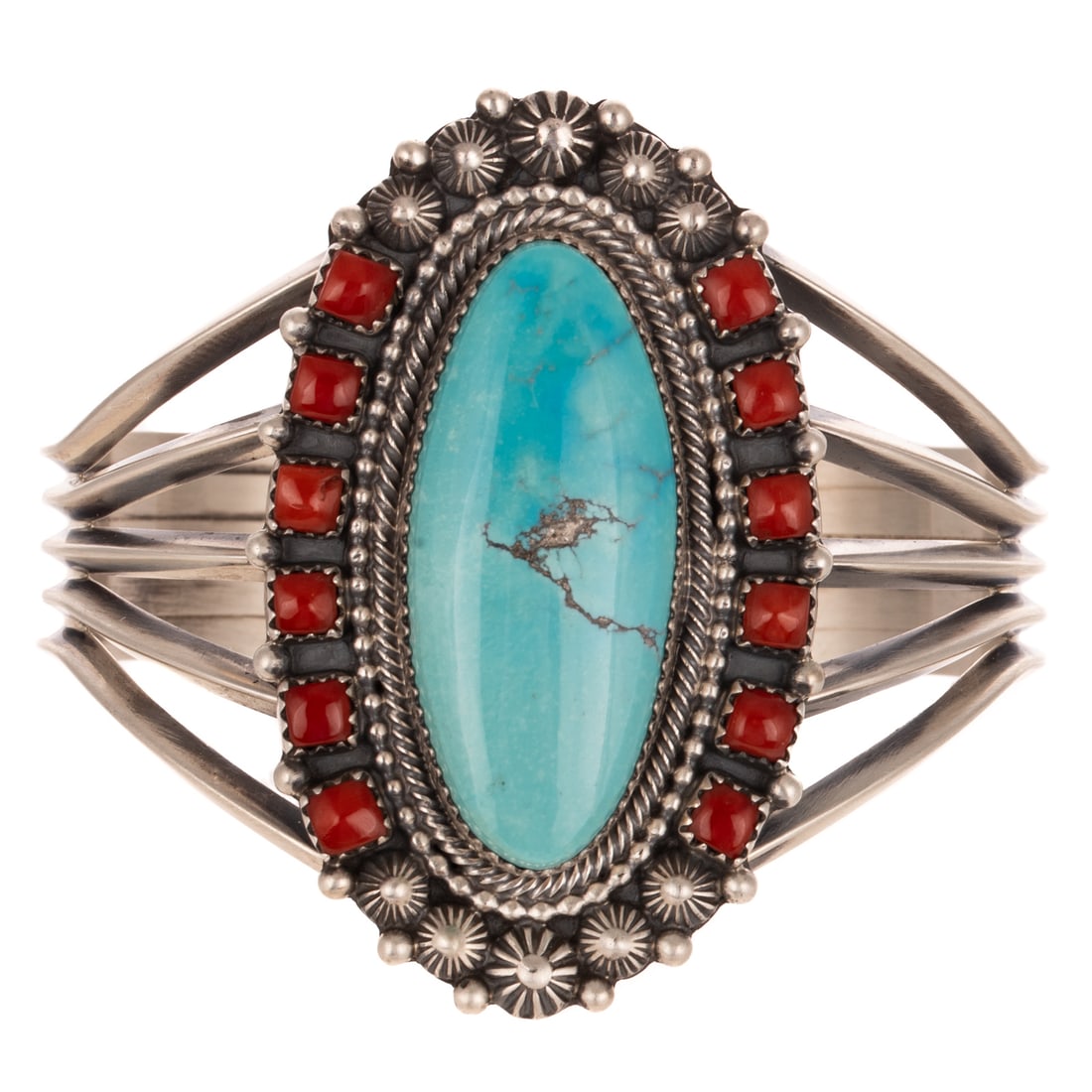 A Tom Lewis Turquoise & Coral Cuff in Sterling Silver: Sterling silver split wire cuff by Navajo artist Tom Lewis, featuring an oval cabochon turquoise, bezel set with rope and bead borders, outer semi halo of square cabochon coral bezel set on either sid