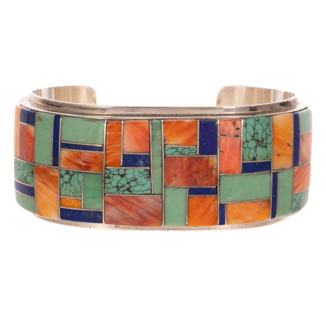 An L. Silversmith Inlaid Cuff in Sterling Silver: Sterling silver cuff by Navajo artist L. Silversmith, 1 1/8 in. W, featuring mosaic inlay of spiny oyster, turquoise, lapis lazuli, and more, signed, 2 1/8 in. interior W, 64.9 grams Provenance: From 